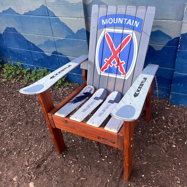 Chair made from recycled skis with a mountain-themed design on a blue mountain background