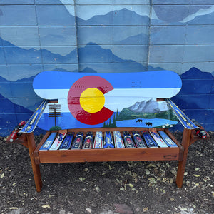Hand Painted Frontier Bench full size chair build with Colorado flag and mountain lake moose scene on reclaimed snowboard backrest, mixed ski seat, and ski armrests on a wood frame