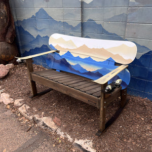Hand Painted Frontier Bench full size chair build with layered mountain scene on reclaimed snowboard backrest, wood plank seat, and ski armrests on a wood rocker frame