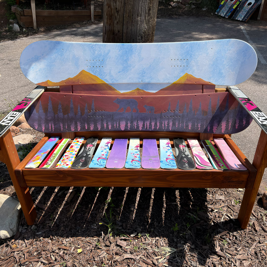 Hand Painted Frontier Bench full size chair build with bear and cub forest scene on reclaimed snowboard backrest, colorful mixed ski seat, and ski armrests on a wood frame