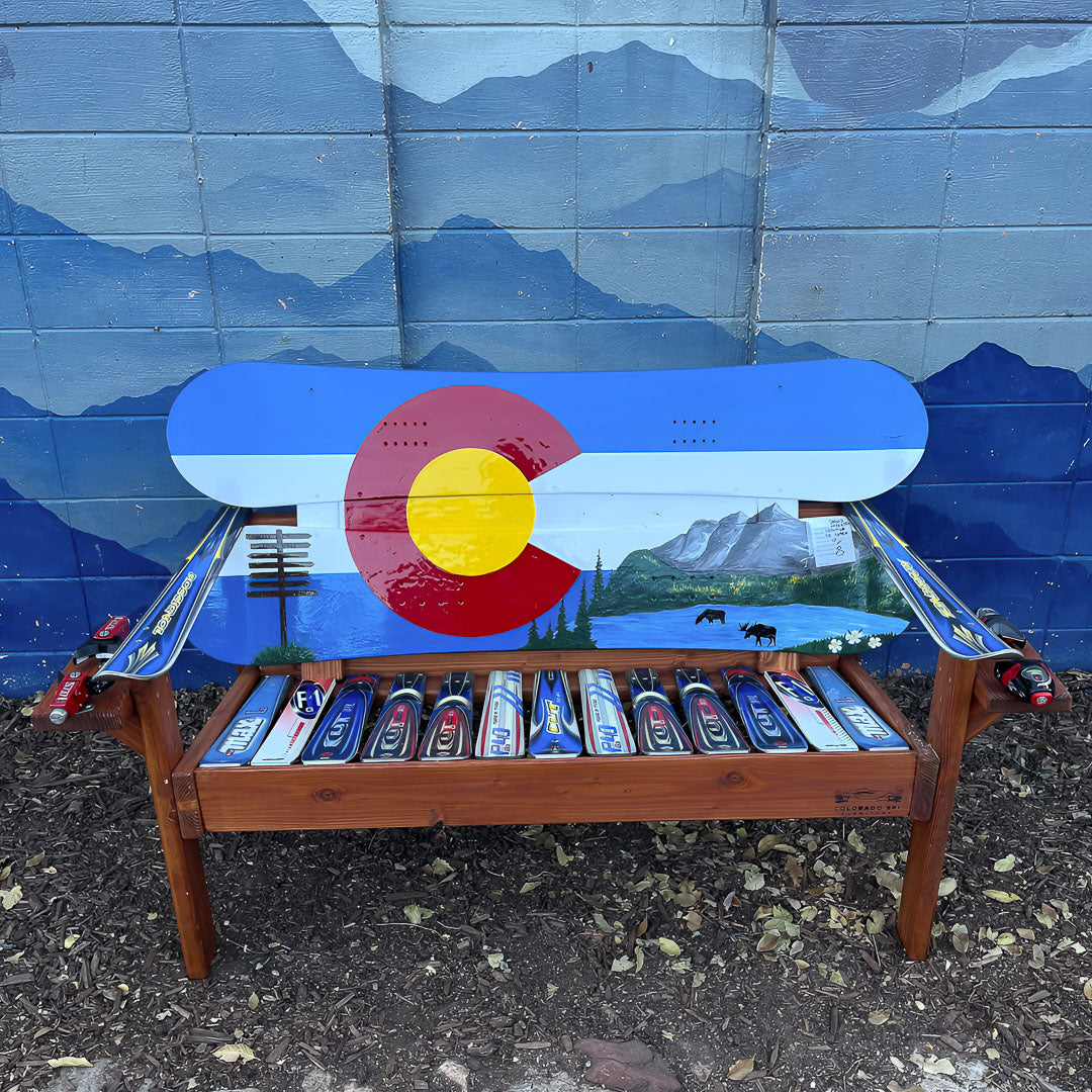 Hand Painted Frontier Bench full size chair build with Colorado flag and mountain lake moose scene on reclaimed snowboard backrest, mixed ski seat, and ski armrests on a wood frame